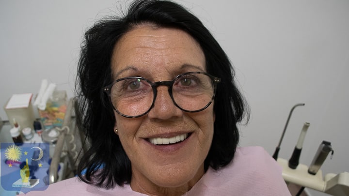 patient smiling after basal dental implants to treat gum disease