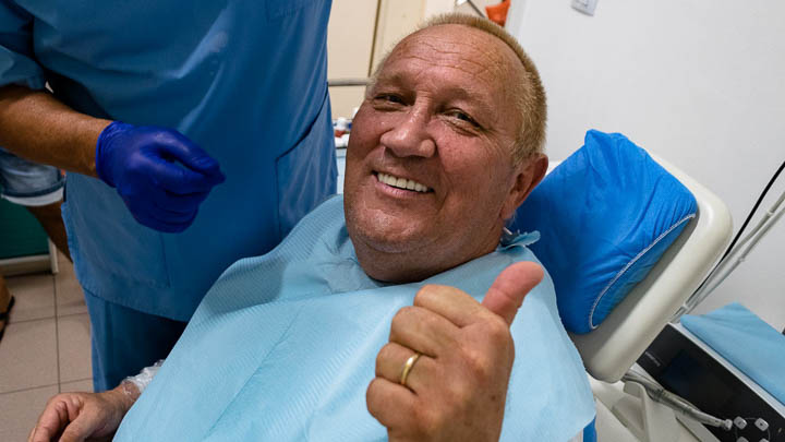 Patient smiling after full dental restoration by DrGenchev for YouTube video