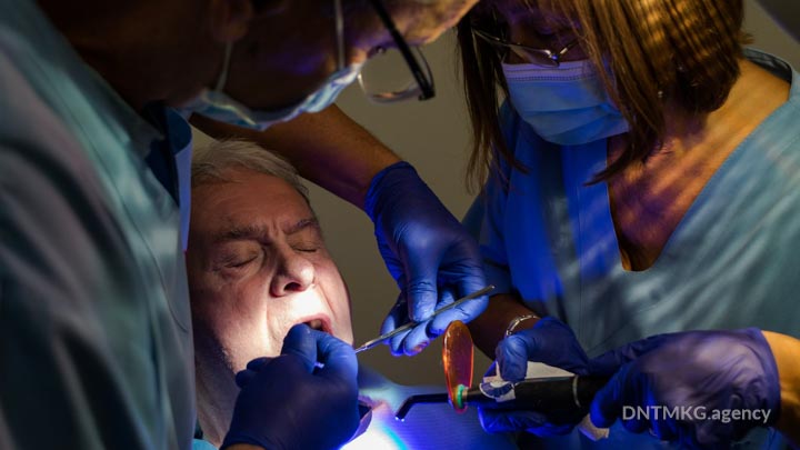 dentist placing a basal dental implant
